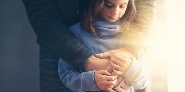 father's arms wrapped around daughter