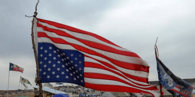 An American flag hangs upside down in an encampment during a protest against plans to pass the Dakota Access pipeline near the Standing Rock Indian Reservation, near Cannon Ball, North Dakota, U.S. November 21, 2016. REUTERS/Stephanie Keith