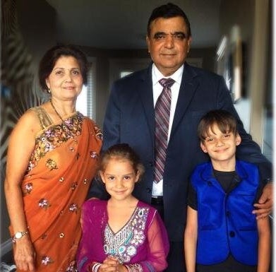 Deepak Obhrai is seen in an undated photo with his wife, and their grandkids Davin, 10, and Evasha, 8.