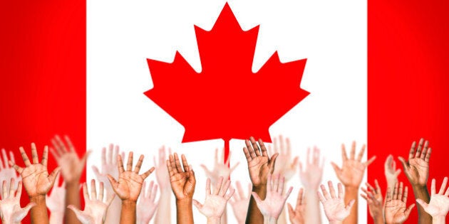 Multi-Ethnic Hands With Flag Of Canada For The Background.