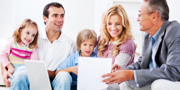Young couple with children talking to financial advisor.
