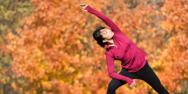 Asian runner stretching in park