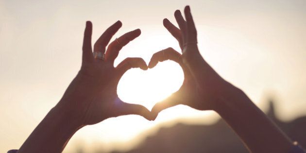 Hands showing heart for the sun.