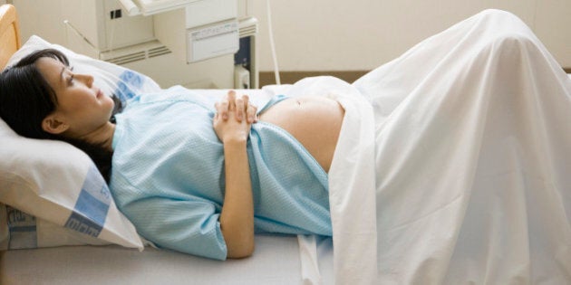 'Pregnant woman lying on hospital bed, elevated view'