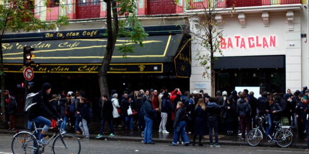 People gather in front of the Bataclan concert hall as France commemorates one year since the Paris terrorist attacks on November 13, 2016 in Paris, France. France pay tributes to the victims of the 2015 Paris terrorists attacks which left at least 130 dead and many others injured by gunmen and suicide bombers from the Islamic State. (Photo by Mehdi Taamallah/NurPhoto via Getty Images)