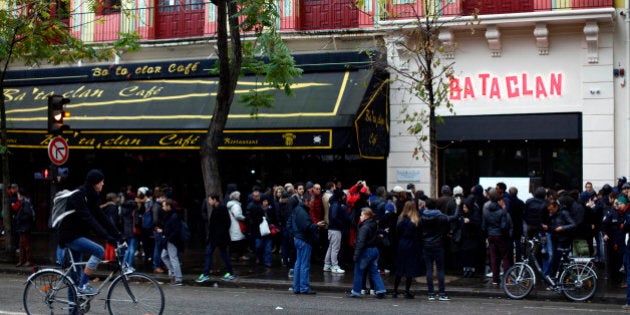 People gather in front of the Bataclan concert hall as France commemorates one year since the Paris terrorist attacks on November 13, 2016 in Paris, France. France pay tributes to the victims of the 2015 Paris terrorists attacks which left at least 130 dead and many others injured by gunmen and suicide bombers from the Islamic State. (Photo by Mehdi Taamallah/NurPhoto via Getty Images)