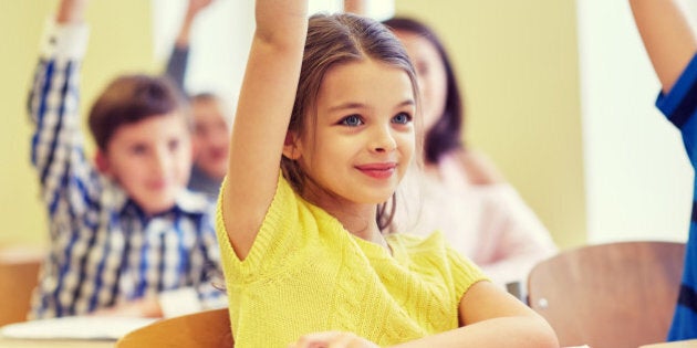 education, elementary school, learning and people concept - group of smiling school kids sitting in classroom