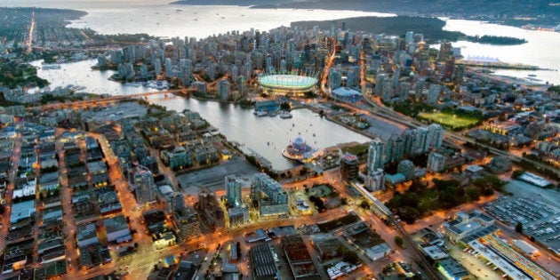 Canada, BC, Vancouver. Aerial view of downtown Vancouver at dusk. False Creek in foreground.