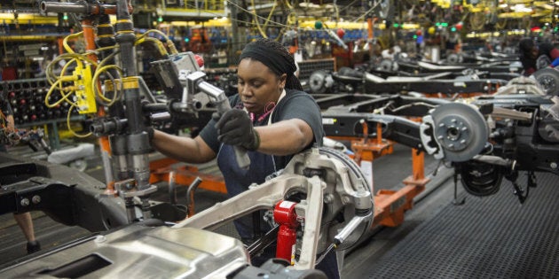 An employee secures the stabilizing bar of a sports utility vehicle (SUV) on the production line at the General Motors Co. (GM) assembly plant in Arlington, Texas, U.S., on Thursday, March 10, 2016. The U.S. Census Bureau is scheduled to release business inventories figures on March 15. Photographer: Matthew Busch/Bloomberg via Getty Images