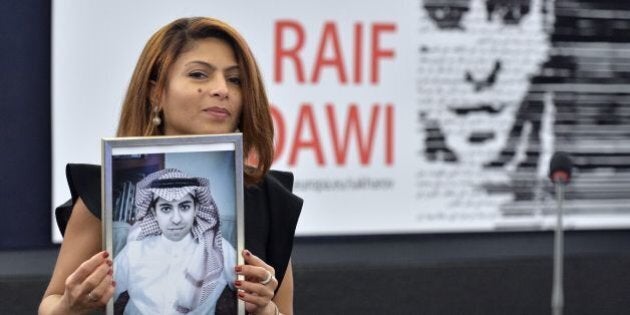 TOPSHOT - Ensaf Haidar holds a picture of her husband Raif Badawi after accepting the European Parliament's Sakharov human rights prize on behalf of her husband, at the European Parliament in Strasbourg, eastern France, on December 16, 2015. Raif Badawi is a Saudi Arabian blogger and author of a website, detained since 2012 on the charge of breaking Saudi technology laws and insulting religious figures. / AFP / PATRICK HERTZOG (Photo credit should read PATRICK HERTZOG/AFP/Getty Images)