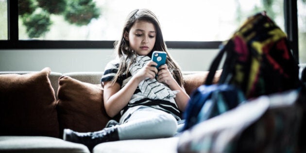 girl (9) using smartphone