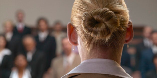 A woman giving a speech in front of an audience