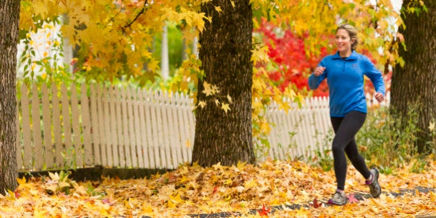 Young woman running in historic Nevada City California durning the fall