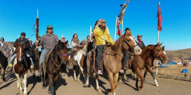 Horse riders from the Bigfoot Riders, Dakota 38 Riders, Spirit Riders and the Bigfoot Youth Riders arrive at the Oceti Sakowin camp during a protest against the Dakota Access pipeline near the Standing Rock Indian Reservation near Cannon Ball, North Dakota November 5, 2016. REUTERS/Stephanie Keith