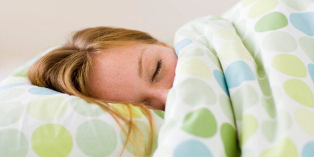 Young woman asleep in bed