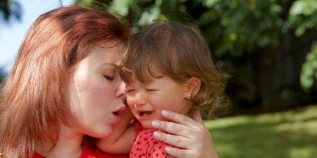 Close-up of a young woman consoling her daughter