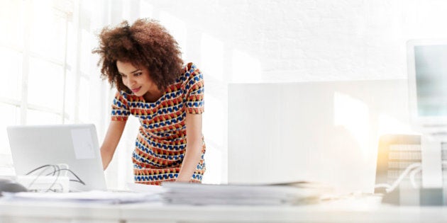 Young business woman working on a laptop.