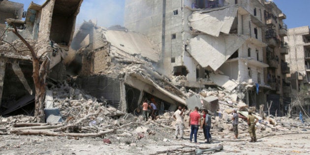 Men inspect a damaged site after double airstrikes on the rebel held Bab al-Nairab neighborhood of Aleppo, Syria, August 27, 2016. REUTERS/Abdalrhman Ismail/File Photo