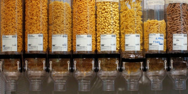 Containers with pasta is displayed at the Original Unverpackt (Original Unpacked) zero-waste grocery store in Berlin's Kreuzberg district September 16, 2014. Original Unverpackt doesn't sell foodstuffs packaged in disposable boxes, bags, jars or other containers instead shoppers can buy the likes of muesli, rice and pasta by directly helping themselves from the large store containers, filling their own boxes before getting them weighed at the till. For beer and red wine, 'bring-your-own' bottles are just as fine, even vodka is stored in a big demijohn from which customers can buy a few shots, or more. The shop also sells washing up liquid and toiletries in bulk, with toothpaste sold in tablet form. The environmentally-friendly project, which was financed by crowd funding, also allows customers to buy far smaller quantities to avoid waste and to invest in the store's recyclable goods. Picture taken September 16, 2014 REUTERS/Fabrizio Bensch (GERMANY)- Tags: SOCIETY FOOD ENVIRONMENT)