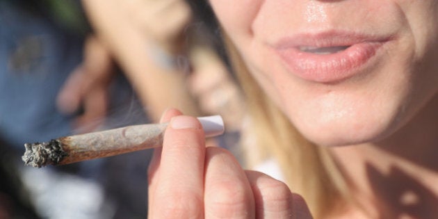 BERLIN, GERMANY - AUGUST 13: An activists smokes a marijuana joint prior to marching in the annual Hemp Parade (Hanfparade) on August 13, 2016 in Berlin, Germany. German proponents of cannabis legalization are hoping that the legalization in several states in the USA in recent years will increase the likelihood of legalization in Germany. (Photo by Sean Gallup/Getty Images)