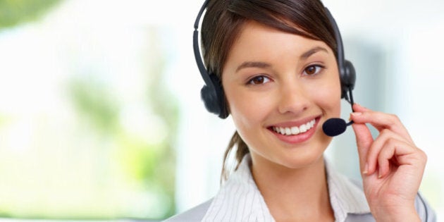 Pretty female employee speaking on headset