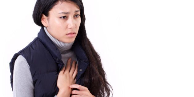 woman suffering from acid reflux or heartburn