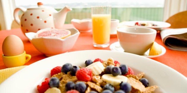 Healthy breakfast of dry cereal and fruit with egg and juice