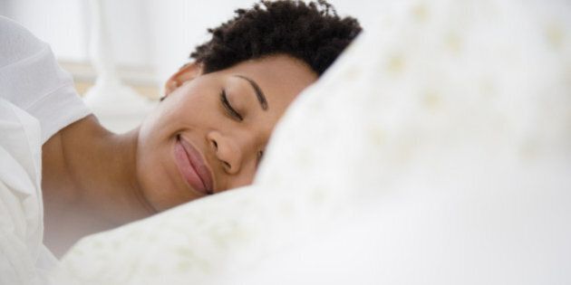 Serene Black woman laying in bed