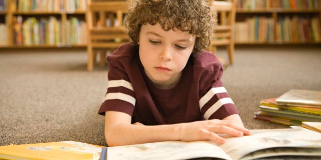 Boy studying in library