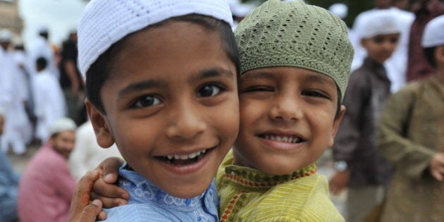 Indian Muslims boys greet one another after Eid al-Fitr prayers at the Qutub Shahi tomb in Hyderabad on August 31, 2011.Muslims around the world celebrated Eid al Fitr which marks the end of the month of Ramadan, after the sighting of the new crescent moon.AFP PHOTO / Noah SEELAM (Photo credit should read NOAH SEELAM/AFP/Getty Images)