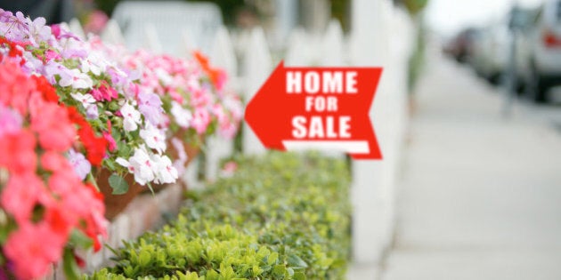 Real estate sign on home for sale.