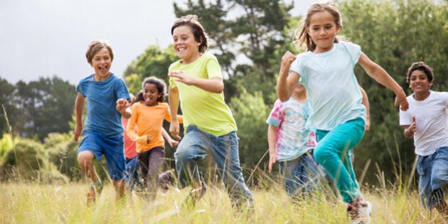 Children, aged 9-10, running together in a park