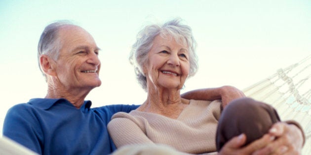 Smiling couple sitting in hammock