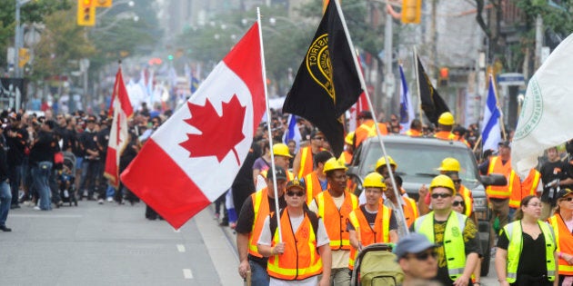 TORONTO, ON - SEPTEMBER 2 - The annual Labour Day Parade was held today starting at University and Queen Sts and ending up in theCNE groundsÃ.UNIFOR,the new superunion was one of the lead marchersÃTom Mulclair and Andrea Horvath were both marching together in the parade as thousands took part in this annual parade for labour (Colin McConnell/Toronto Star via Getty Images)