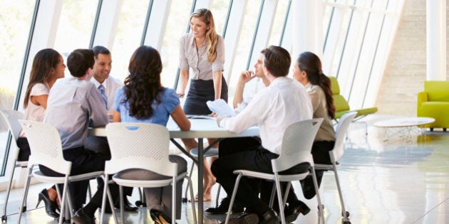 Business People Having Board Meeting In Modern Office