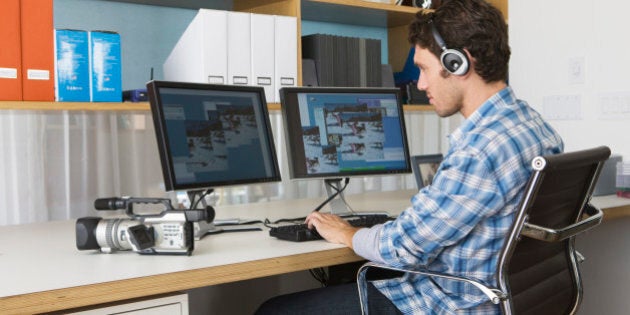 man video editing in his home office