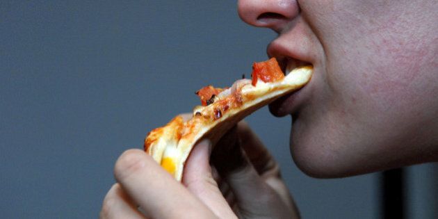 Generic shots of a person eating a pizza from Pizza Hut.