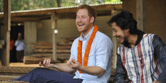 Britain's Prince Harry laughs as he tries wood carving in heritage sites at Patan Durbar Square on the outskirts of Kathmandu, Nepal, Sunday, March 20, 2016. Harry began a five-day official trip to Nepal on Saturday, meeting with Prime Minister Khadga Prasad Oli and attending a ceremony to mark 200 years of relations between the two nations. (Prakash Mathema via AP)