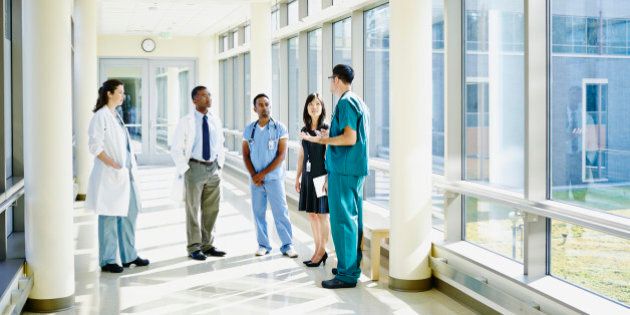 Medical team in discussion in hospital corridor