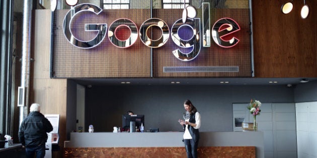 An employee checks her mobile device in the lobby of Google Canada's engineering headquarters in Waterloo, Ontario, Canada, on Friday, Jan. 22, 2016. The 185,000-square-foot facility currently houses over 350 employees from Google's Canadian development team. Photographer: Cole Burston/Bloomberg via Getty Images