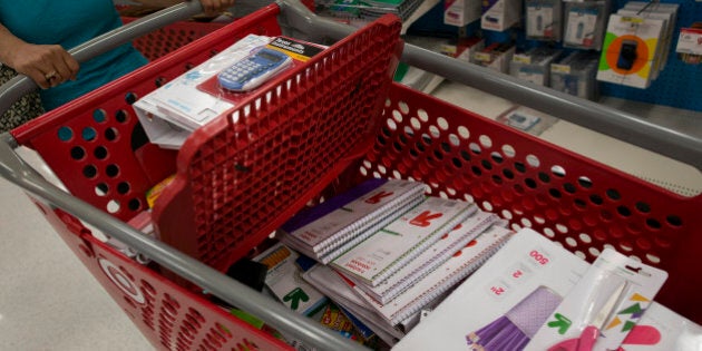 Back to school supplies sit inside a customer's shopping cart at a Target Corp. store in Colma, California, U.S., on Saturday, Aug. 9, 2014. Retailers are pushing for a longer shopping season and earlier than ever deals on order to get customers to buy more over a longer period of time, says DealNews spokesman Mark LoCastro, which tracks price and discount trends across the web, according to USA Today. Photographer: David Paul Morris/Bloomberg via Getty Images