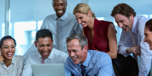 Happy multi-ethnic businesspeople having video conference in office