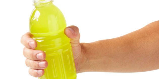 Hand holding sports drink, larger files come with clipping path.