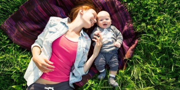 Baby and mother on nature in the park. Ljubljana,