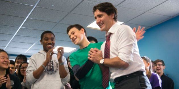 TORONTO, ON - FEBRUARY 12, 2016 Christopher Belnavis-Giant, 17, applauds as he watches Oscar Teixeira, 16, congratulate Prime Minister Justin Trudeau following a friendly game of foosball at the Boys and Girls Club in Toronto. PM Justin Trudeau announces a budget increase for summer jobs program for students to $113 million. (Chris So/Toronto Star via Getty Images)