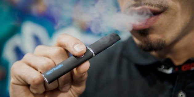 A representative from Sky High smokes from a vaporizer during the Champs Trade Show in Las Vegas, Nevada, U.S., on Tuesday, Jan. 21, 2014. Champs is a business-to-business expo for distributors of smoking-related paraphernalia. Photographer: Jacob Kepler/Bloomberg via Getty Images