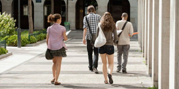 University students walking on campus, rear view