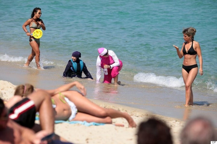 Get 'em off! Armed police order Muslim woman to remove her burkini on  packed Nice beach - as mother, 34, wearing Islamic headscarf is threatened  with pepper spray and fined in Cannes