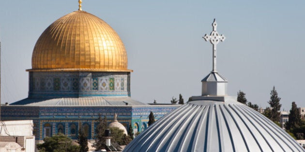 The silver dome of Our Lady of the Spasm Armenian Catholic Church and the golden Dome of the Rock rise over the Old City of Jerusalem.