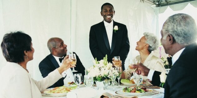 Young Man Standing to Give a Speech at a Wedding Reception